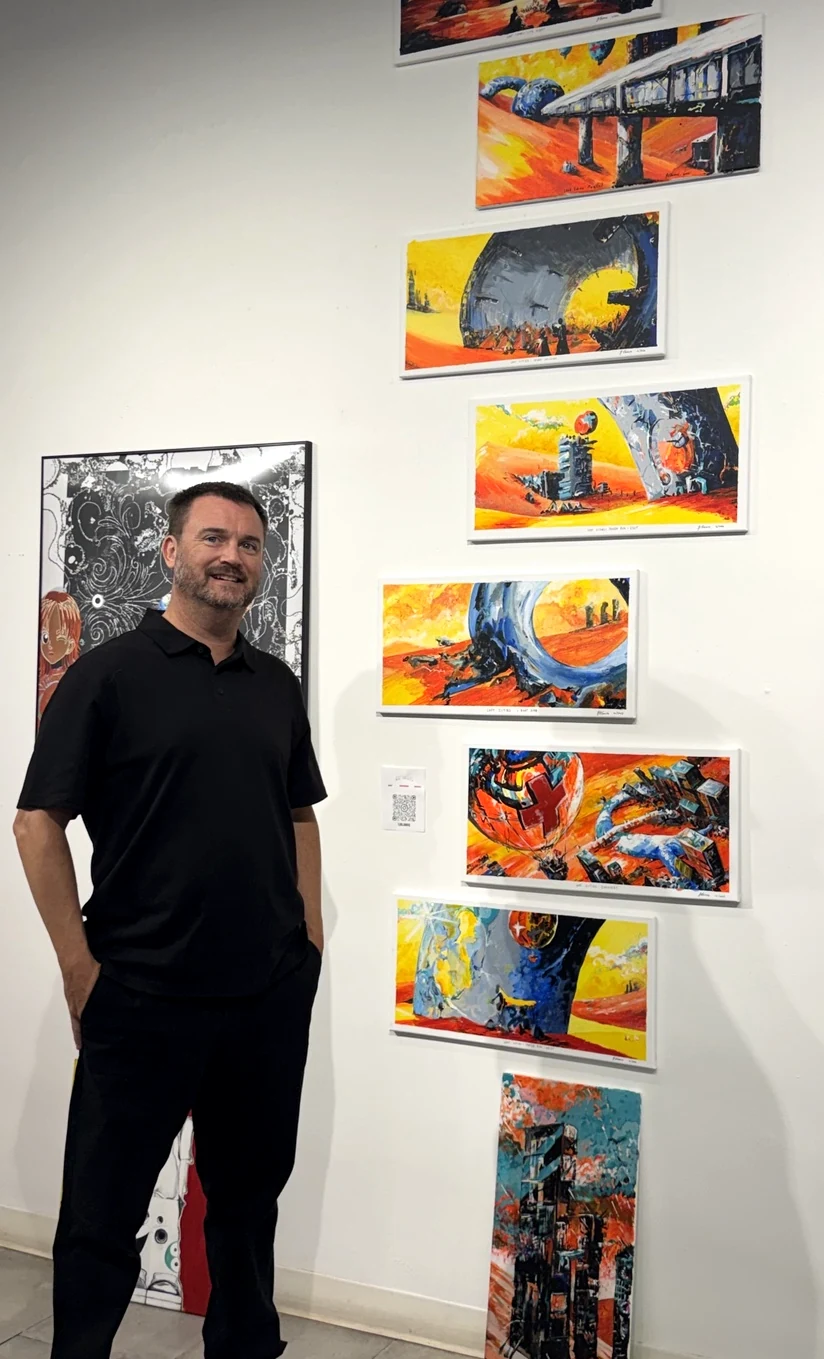 TJ Blamire with paintings from his Lost Cities series at the ArtGroove exhibition in Tribeca, October 2026
